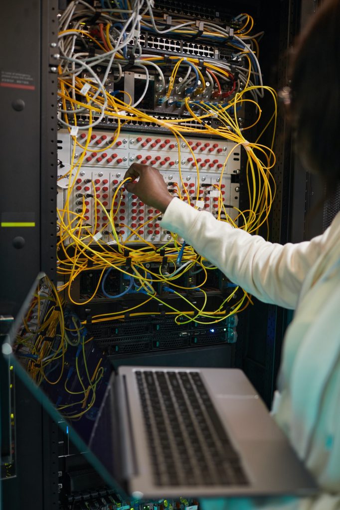 Female Network Technician Connecting Cables Close Up